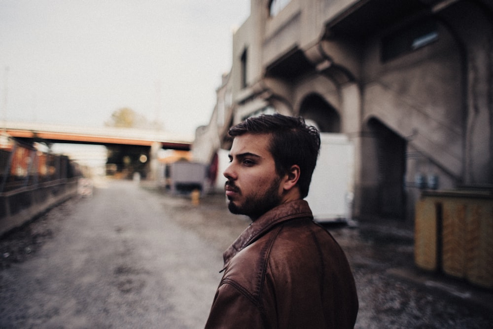 a man standing on a street next to a building