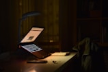 gray laptop computer turned on while in tilting position