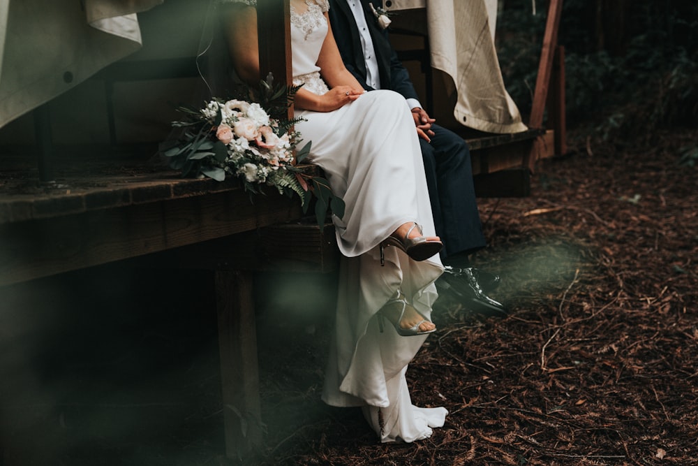 bride and groom sitting and holding their hands