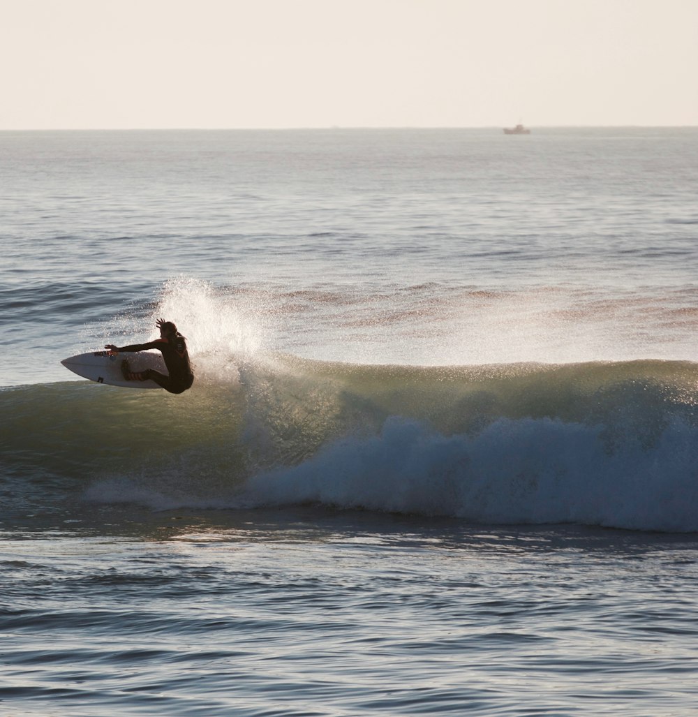 surfer performing tricks on seawave
