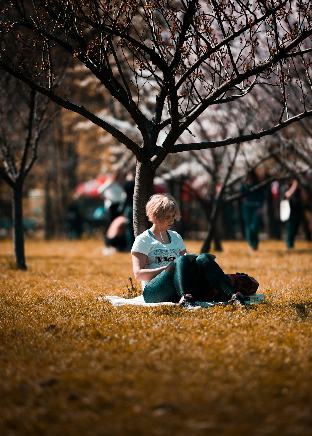 woman sitting under tree