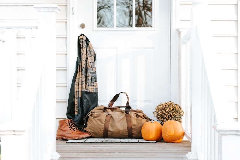 brown duffel bag in front of door
