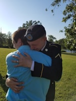 A veteran and family member embracing during a community outreach event.