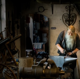 blacksmith holding mallet in garage