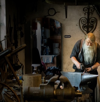 blacksmith holding mallet in garage