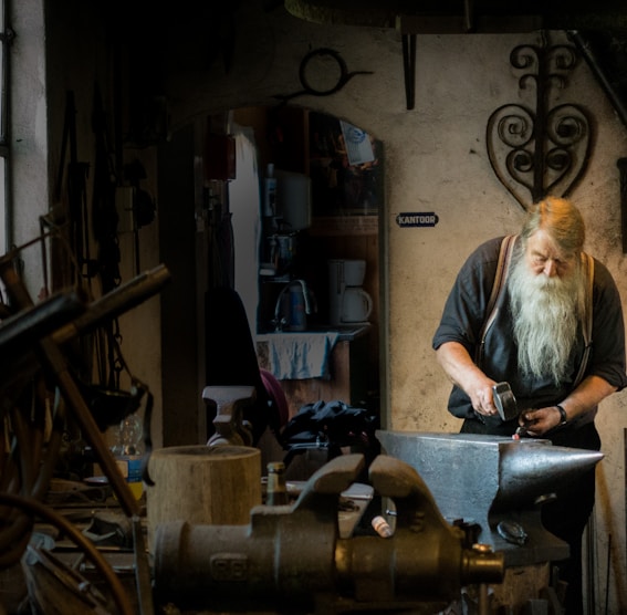 blacksmith holding mallet in garage