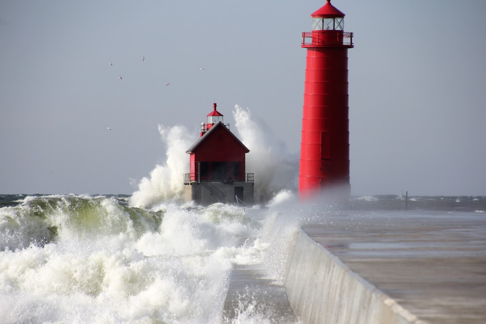 red lighthouse near sea