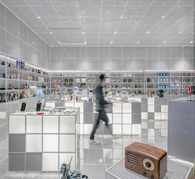 man walking beside white cube decoration