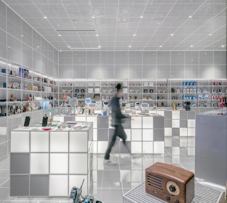 man walking beside white cube decoration