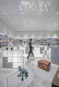 man walking beside white cube decoration