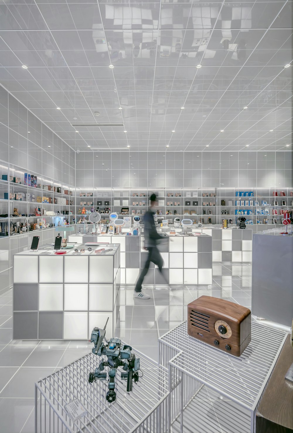 man walking beside white cube decoration