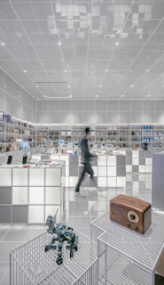 man walking beside white cube decoration