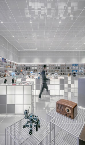 man walking beside white cube decoration