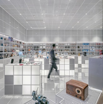 man walking beside white cube decoration