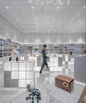 man walking beside white cube decoration