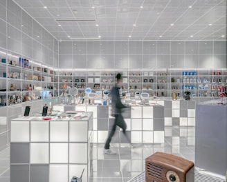 man walking beside white cube decoration