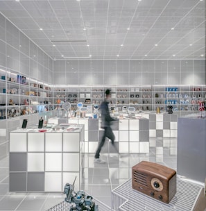 man walking beside white cube decoration