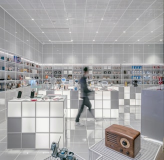 man walking beside white cube decoration