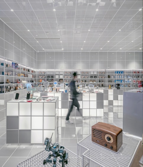 man walking beside white cube decoration