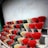 A collection of colorful ritual candles and incense sticks displayed on a wooden table.