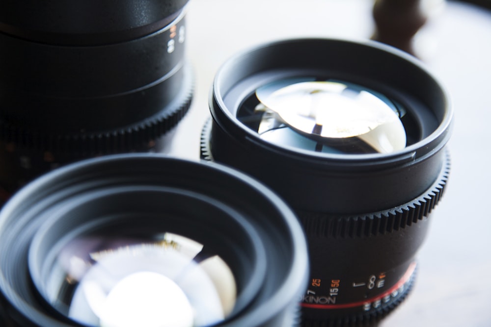 two black telephoto lens on tabletop