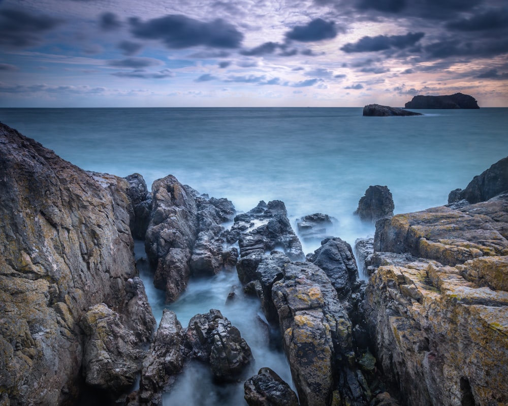 body of water beside rock monument