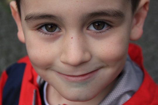 A warm portrait of a child smiling gently, symbolizing hope and resilience.