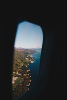 A scenic view of a travel destination with an airplane flying in the sky.