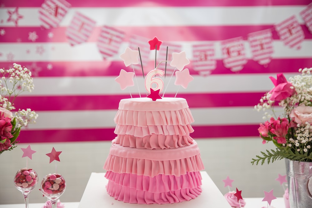 pink birthday cake on tabletop