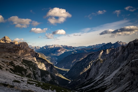 aerial photography of mountain under blue sky and white clouds in Drei Zinnen Nature Park Italy