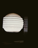 3D printed rigatone lamp casting playful shadows on a white wall.