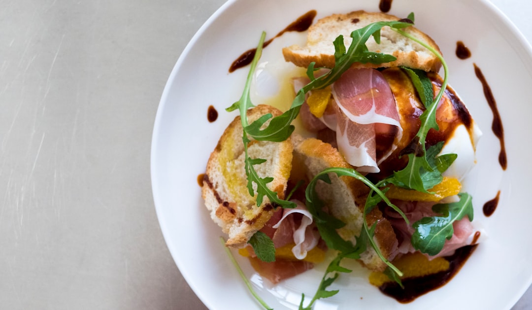 flat-lay photography of meat sandwich with vegetable toppings