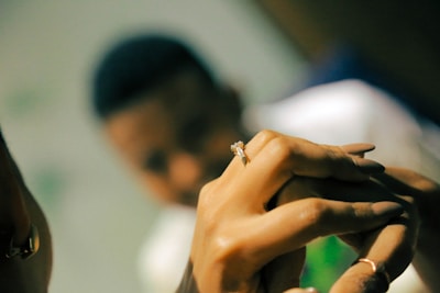 A close-up of a wedding ring on a romantic background.