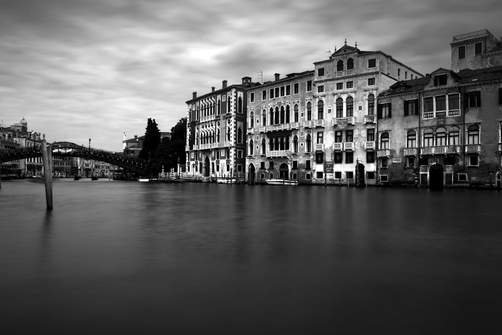 concrete buildings beside body of water