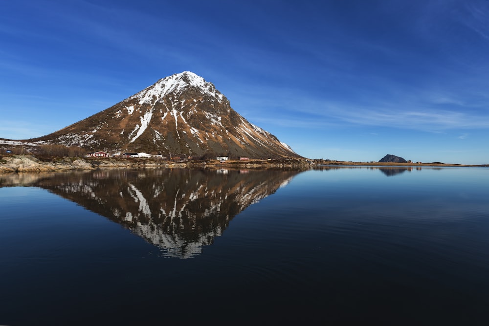 mountain beside body of water