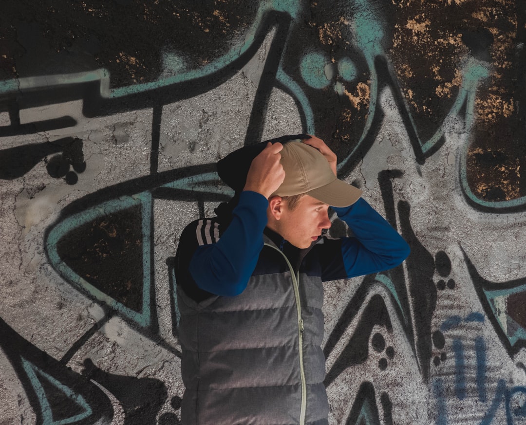 man standing near wall art