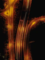 Night view of an illuminated highway interchange showcasing smooth traffic flow and structural design.