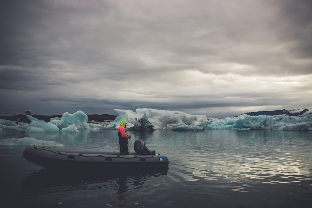 person riding boat while fishing