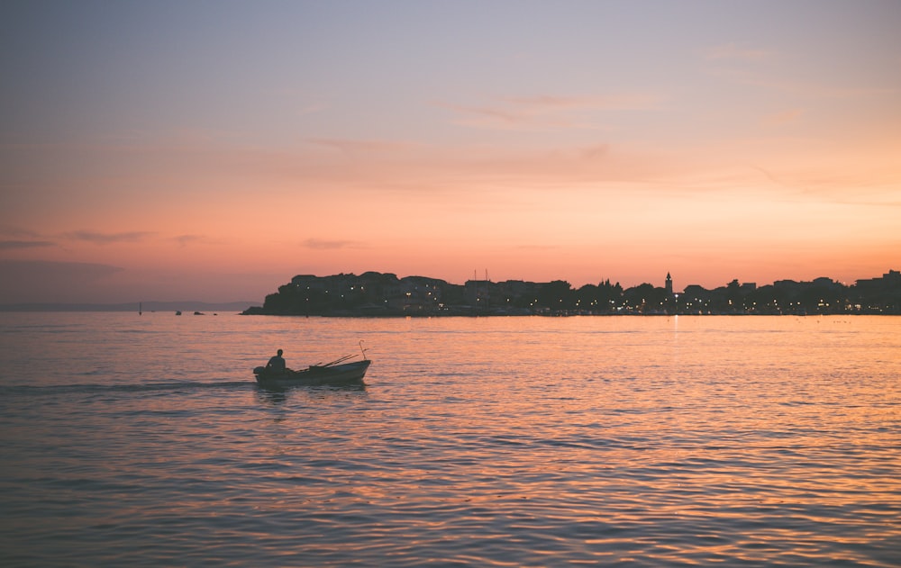 man riding boat during nighttime