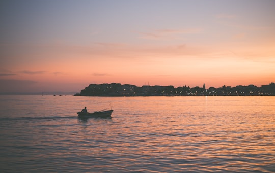 man riding boat during nighttime in Podstrana Croatia