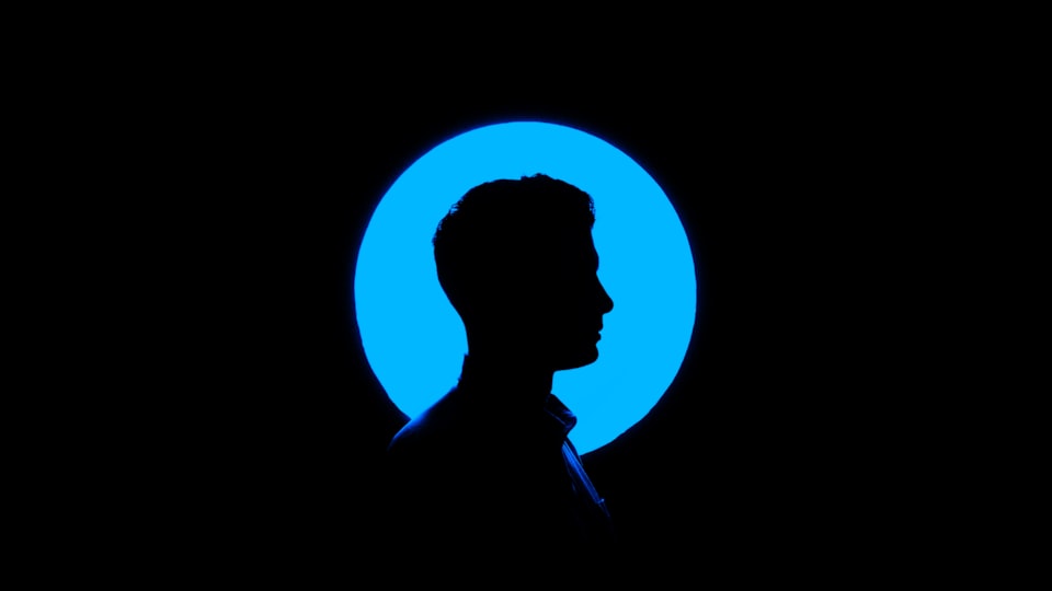 Silhouette of a man against a blue circle and black background.