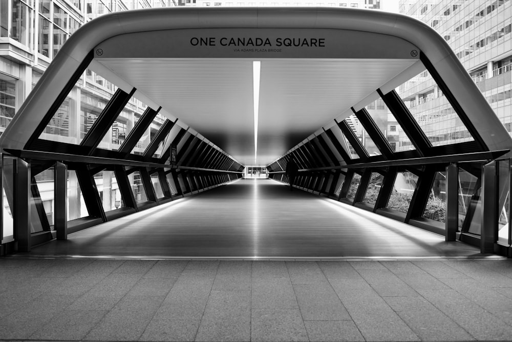 gray scale photo of One Canada Square pathway