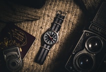 analog watch on brown textile