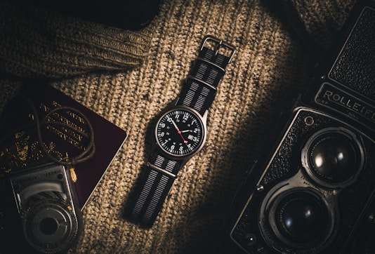 analog watch on brown textile