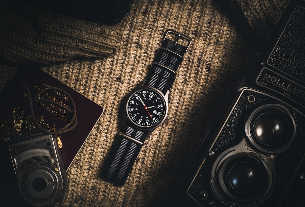 analog watch on brown textile