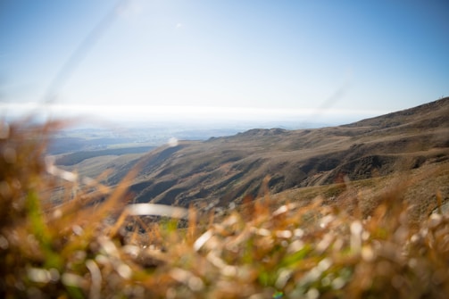 A panoramic view of rolling hills under a vast blue sky, perfect for development.