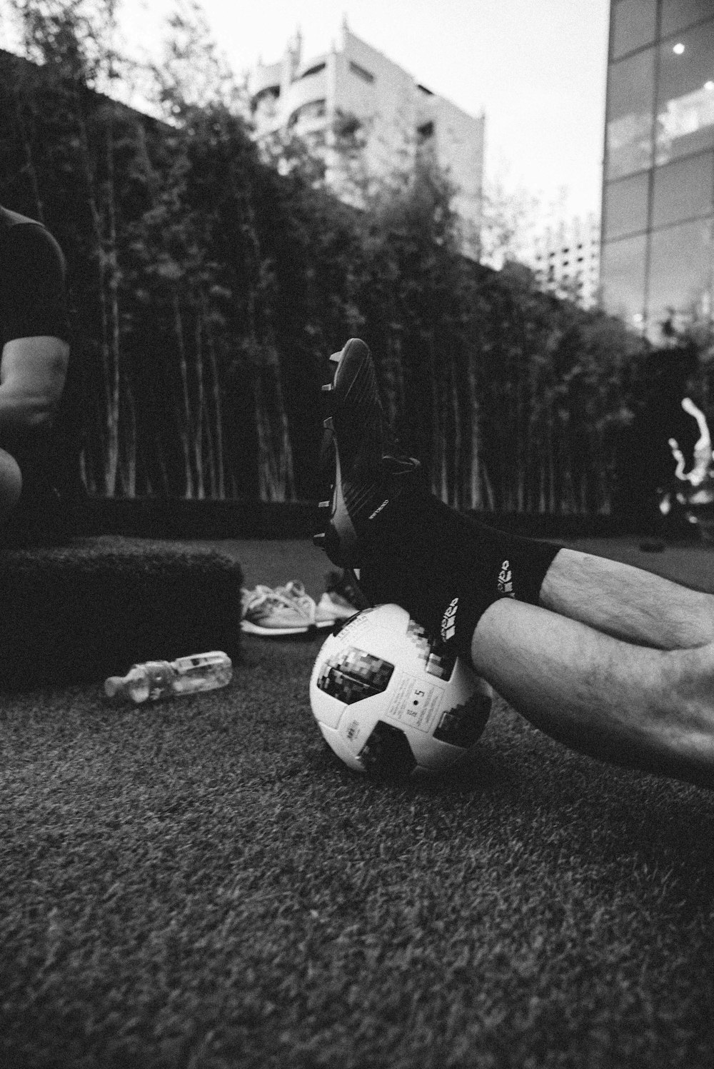 gray scale photo of a person's feet on a football