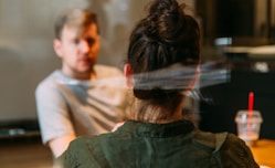 person sitting in a chair in front of a man