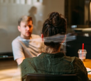 person sitting in a chair in front of a man