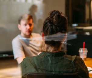 person sitting in a chair in front of a man